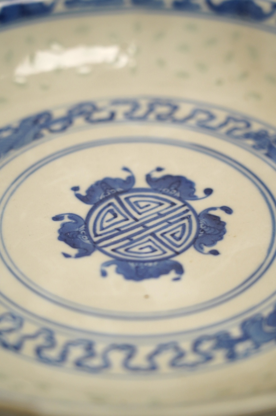 Four Chinese blue and white export plates and a rice bowl, bowl 24.5cm diameter. Condition - poor to fair, some damage to the edges